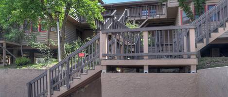 A multi-story building with a staircase leading to a balcony.