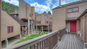 A multi-story building with a wooden deck and a red door. - The Blue Bear | Trails, Golf, Pool & Hot Tub - Near Town (Durango)
