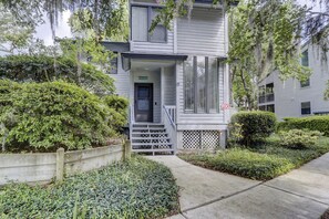 Welcome to a charming home with a small porch and steps leading to the front door.