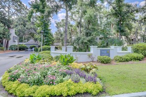 Stroll through the beautifully landscaped grounds of Treetops Ocean Breeze, surrounded by lush greenery and vibrant flowers.