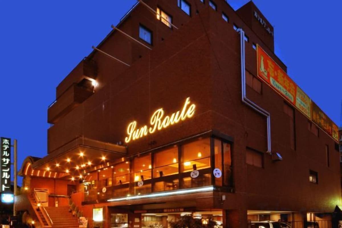 A building with a prominent illuminated sign reading 'Sun Route.'