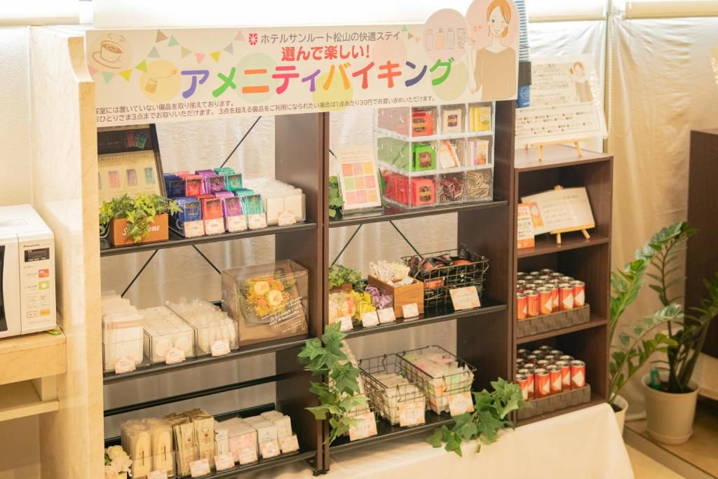 A display of various packaged goods, possibly for sale, arranged on shelves with price tags.