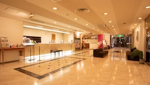 A spacious lobby with a reception desk, a cashier, and a reception area.