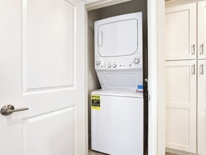 In-Unit Laundry Closet with Stacked Washer and Dryer