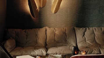 A modern living room with a sofa, a coffee table, and decorative wall art.