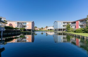 Stroll along the tranquil canal, taking in the serene views of the surrounding buildings.