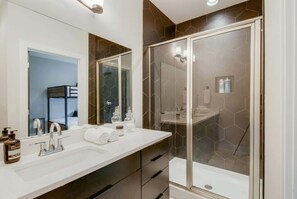 Bathtub, hair dryer, towels, shampoo