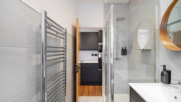 Shower, hair dryer, towels, shampoo