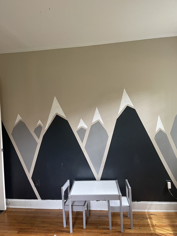 Unique geometric wall design adds a modern touch to this stylish space, perfect for dining or meetings.