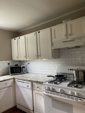 Enjoy cooking in this fully equipped kitchen with a gas stove, microwave, and dishwasher.