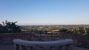 A stone bench with a view of rolling hills and a clear sky. - Large bedroom (3 + 1 baby ) & Dining area in a country village -  (Lézat-sur-Lèze)