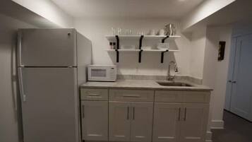 Fridge, microwave, coffee/tea maker, cookware/dishes/utensils