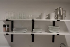 Fridge, microwave, coffee/tea maker, cookware/dishes/utensils