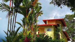 A two-story building with a red roof, surrounded by lush tropical vegetation. - Perfect viewing of migrating Pacific whales, from the hills above Ojochal (Ojochal)