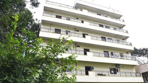 Un immeuble à plusieurs étages doté de balcons et de climatiseurs.