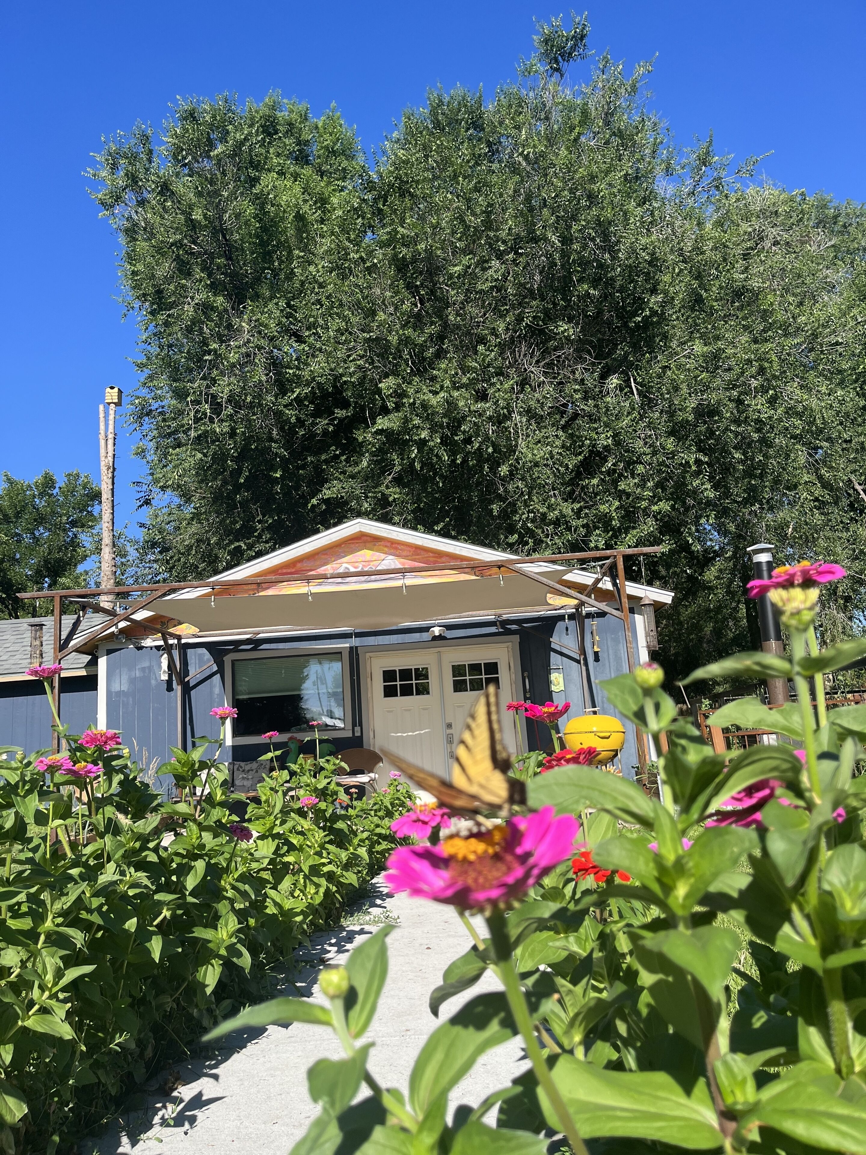A house with a sloped roof, a front door, and a garage.