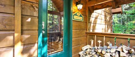 Welcome to 971 Cupid's Dart, a cozy cabin with a wooden deck and an entrance.