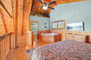 A wooden cabin interior with a bedroom, bathroom, and a balcony. - Serenity- Find your solitude at the 1 bedroom cabin! (Gatlinburg)