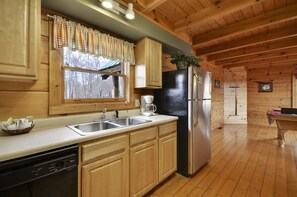 Compact kitchen with sink, coffee maker, and dishwasher.