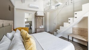 A modern bedroom with a large bed, a glass staircase, and a walk-in closet. - Villa la Duccia - Homelike Villas (Monterubbiano FM)
