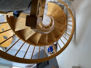 Staircase leads to an upper floor with a central handrail and banister.