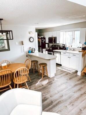 Enjoy cooking and dining in this well-equipped kitchen with a central island, dining area, and modern appliances.