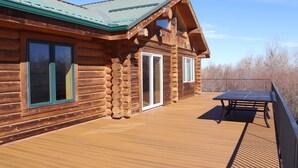A wooden cabin with a deck and a table. - Montana Wildflower Lodge~sleeps 10 (Red Lodge)