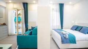 A modern hotel room with a bed, a sofa, and a desk. - RED LION APARTMENT x6 (Sorrento)