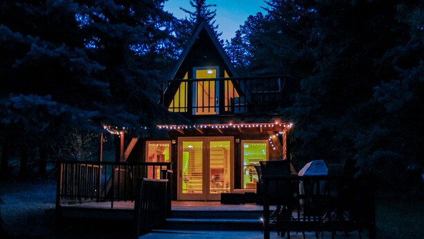 A cabin with a porch, steps leading to the entrance, and a grill outside. - Riverside A-Frame Close to RMNP, 2 BDR King, 1 BTH, Fireplace, Adventure Awaits (Lyons)