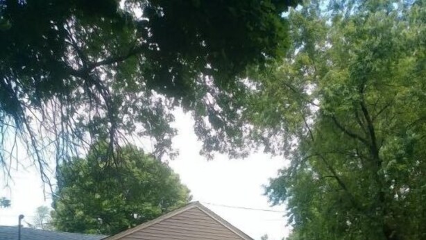 A single-story house with a front door, a small porch, and a visible garage door.