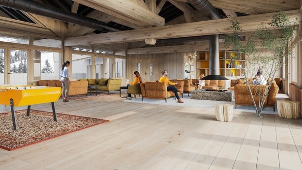 A spacious indoor area with wooden beams, a pool table, sofas, and a fireplace.