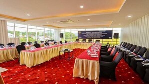 A conference room with a long table, chairs, and a banner. - Labersa Toba Hotel and Convention Centre Balige (Balige)