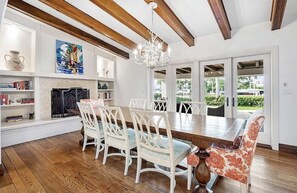 Cozy dining area with a large table, comfortable chairs, and a fireplace.