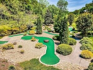 Play a round amidst lush gardens and winding paths.