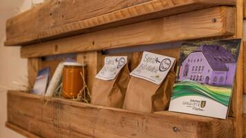 A wooden display case with labeled bags and a postcard.