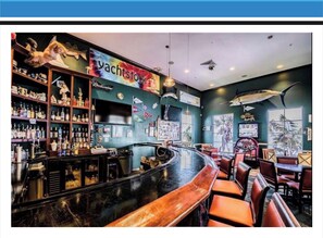A bar area with a curved counter, wooden chairs, and a sign reading "Waterside Yacht Club". - Waterfront Resort Style Condo (St. Petersburg)