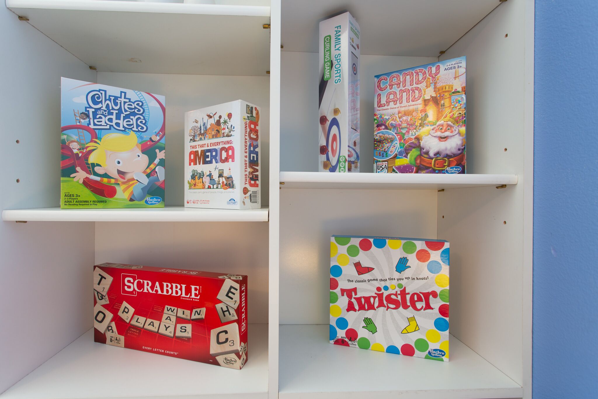Four shelves with various board games.