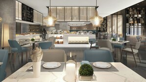 Un restaurante moderno con barra central, zonas de estar y cocina a la vista.