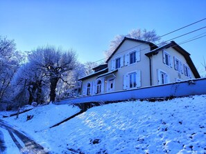 A two-story house with a sloped roof, multiple windows, and a visible front porch. - A peaceful natural oasis with woods and a stream—near Basel, Colmar, and Europa-Park (Basel)