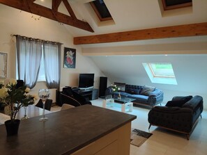 A living room with a TV, sofa, and coffee table.