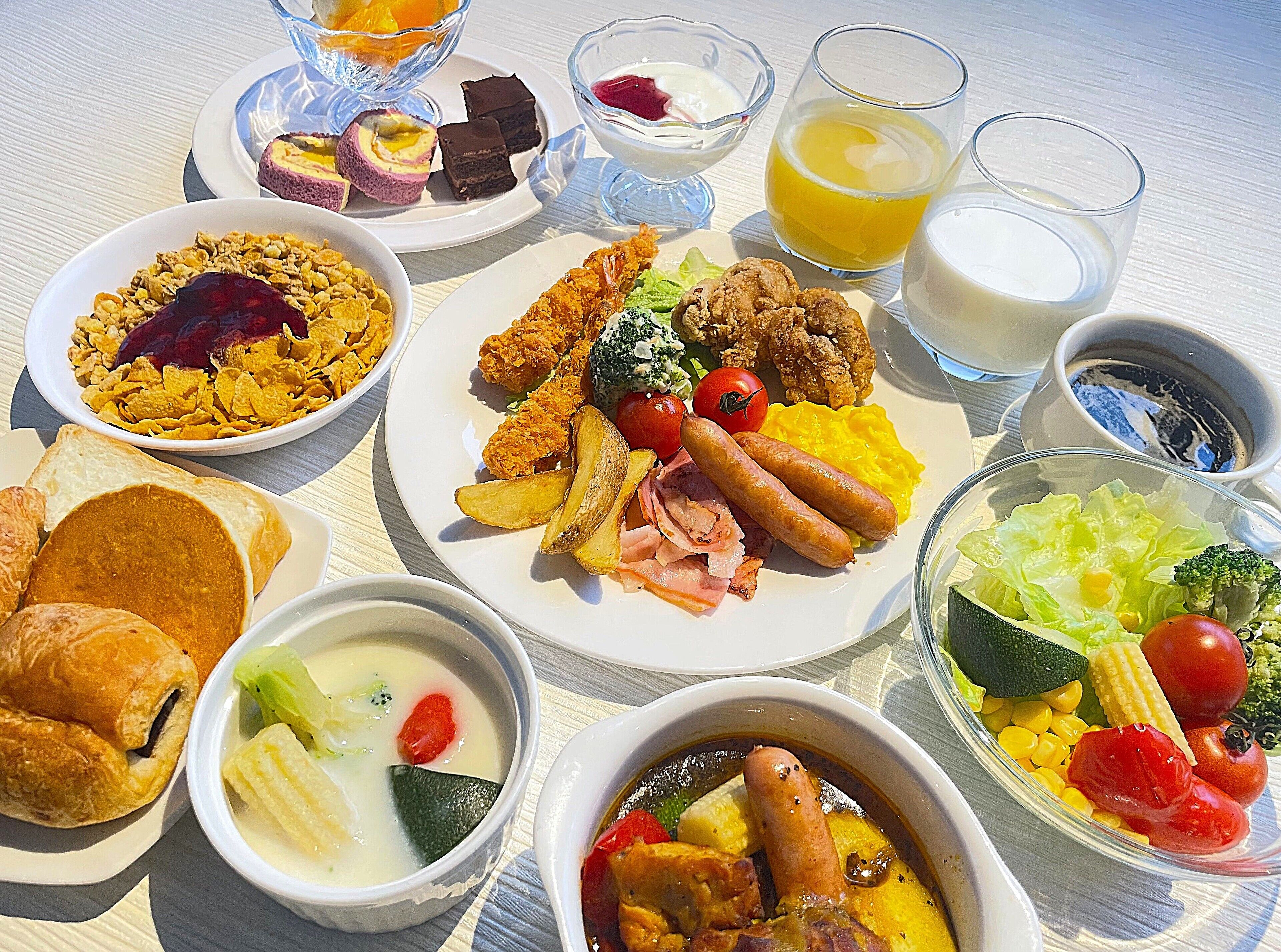 A variety of breakfast dishes including sausages, eggs, and toast.