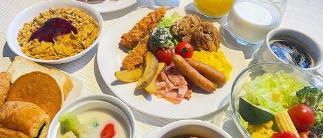 A variety of breakfast dishes including sausages, eggs, and toast.