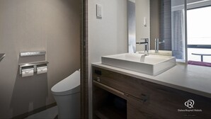 A modern bathroom with a large mirror, a white sink, and a toilet. - Daiwa Roynet Hotel Osaka Sakaisuji Honmachi PREMIER (Osaka)