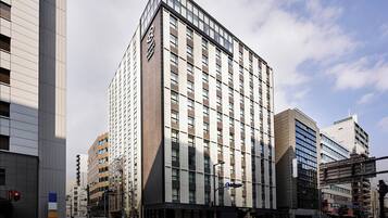 Located in an urban setting, the hotel features a glass facade with evenly spaced windows.