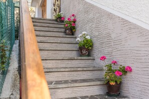 A staircase with potted plants on each step.