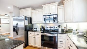 Dishwasher, coffee/tea maker, cookware/dishes/utensils, dining tables