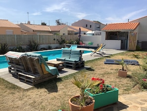 A backyard with a swimming pool, lounge chairs, and a small garden area. - House with land in the heart of the thatched-roof district and near the ocean (Les sables d olonne)