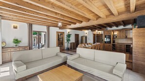 A spacious living area with a wooden ceiling, a large sofa set, and a wooden coffee table. - Villa Dali with whirlpool, sauna and 5 bedrooms (Svetvinčenat)