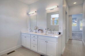 A modern bathroom with a double sink vanity, a large mirror, and a window above the sink. - New Contemporary Mountain Home - 12 Min. to Durango - Central AC - Views (Durango)