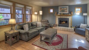 A living room with a fireplace, a sofa, a recliner, and a coffee table. - Mesa Haven | Downtown Durango Access, Pool/Hot Tub, Near FLC and Golf (Durango)